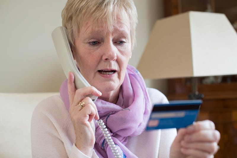 A senior gives personal information to a scammer