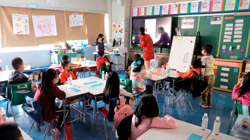 (L-R) Co-teachers at Yung Wing School P.S. 124 Marisa Wiezel (who is related to the photographer) and Caitlin Kenny give a lesson to their masked students in their classroom on September 27, 2021 in New York City. 