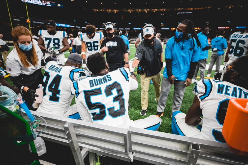 Brian Burns fist bumps defensive coordinator Phil Snow