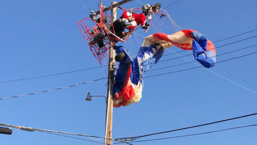 Santa flying on powered parachute has to be rescued from power lines