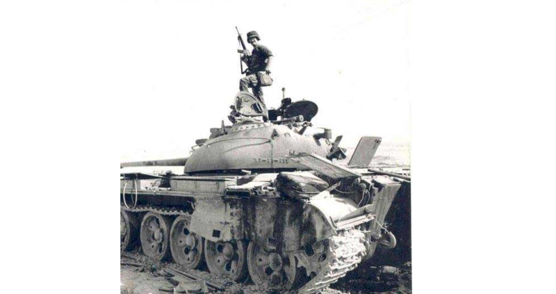 Dave Boe poses on top of a destroyed Iraqi tank after Desert Storm. Photo courtesy of the author.