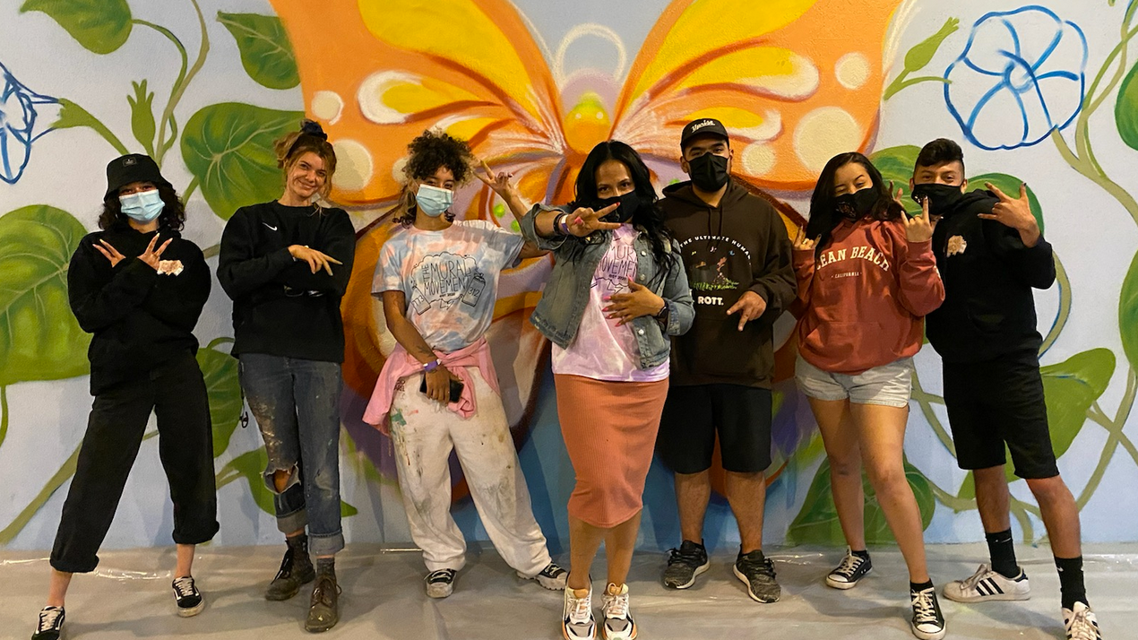 Artists paint mural inside shelter for unaccompanied migrant children