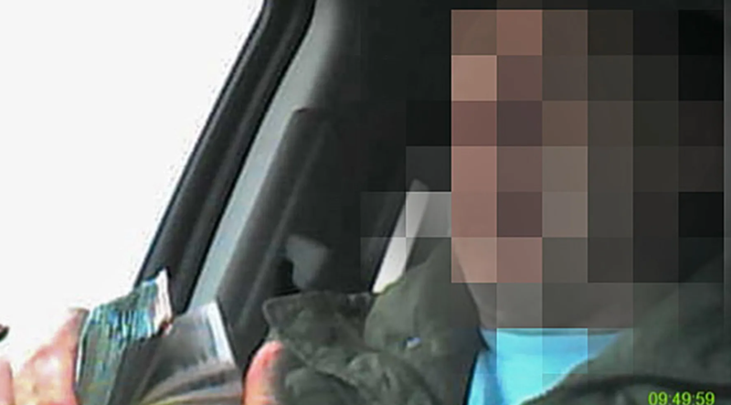 A Cook County Board of Review employee allegedly counts thousands of dollars in bribe money for lowering property assessments, according to a photograph attached to a federal affidavit obtained by the Sun-Times. The Sun-Times is not naming the employee and has pixelated his face; he is not charged. 