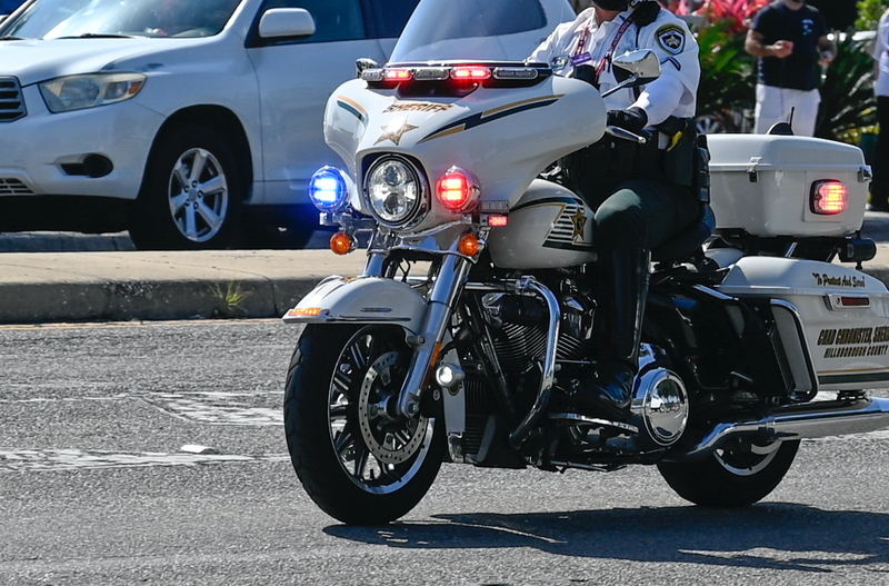 A police officer rides a motorcycle.
