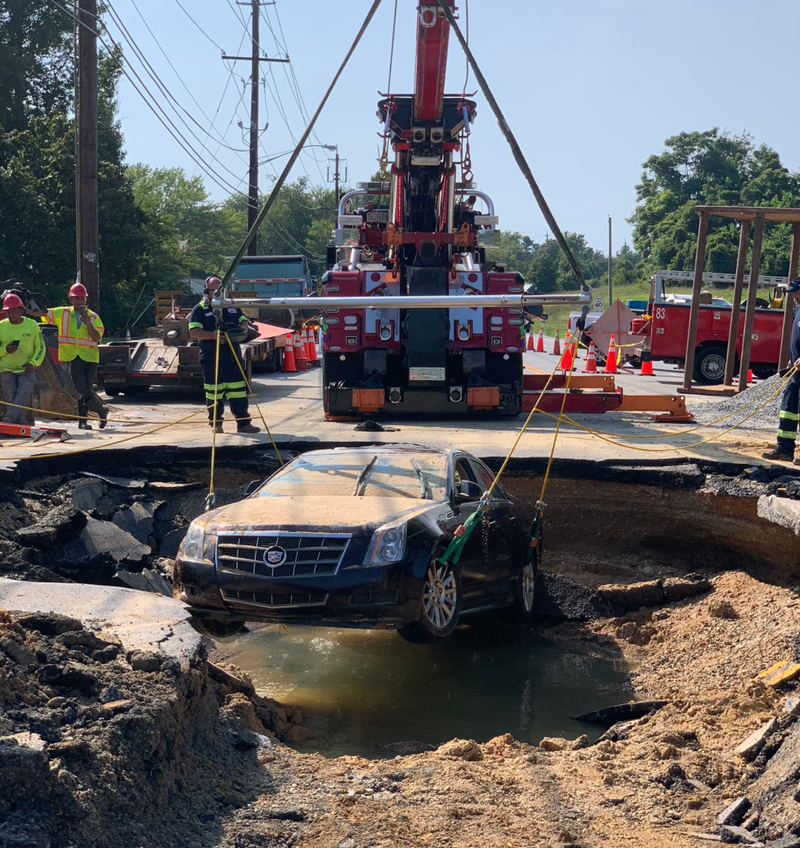 A submerged Cadillac is removed from 12-foot sinkhole.