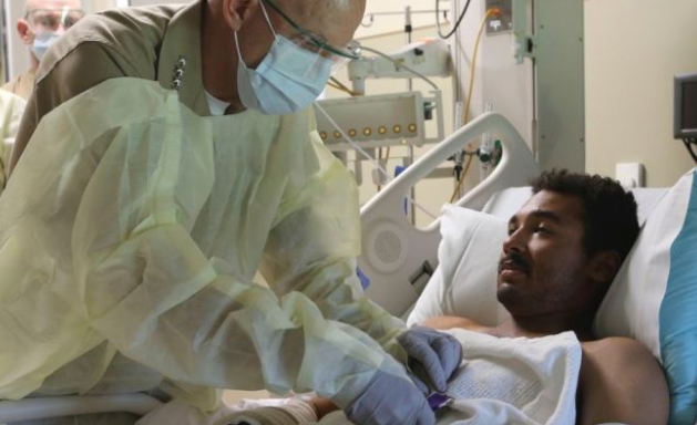 Lance Cpl. Romel Finley III in hospital bed