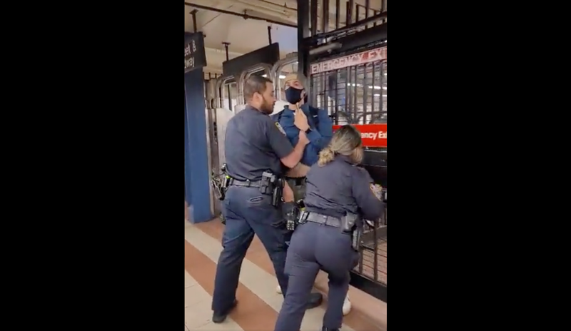 Two NYPD officers were filmed forcibly ejecting MTA subway rider Andrew Gilbert after he confronted them about not wearing masks during his morning commute Tuesday.