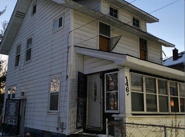 The aftermath of two-story home fire and window the man jumped out of 