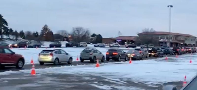 Cars lined up for a free PCR test in Sterling Heights
