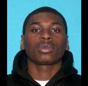 Black man in 20s wearing black hoodie 