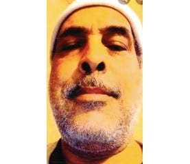 Older man in beanie with gray stubble 