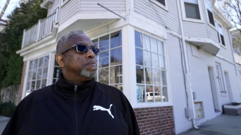 Terrell Osborne stands for a portrait in front of a of Providence, R.I. antique shop that was a general store in the early 1960s in what was then known as the Lippitt Hill neighborhood.
