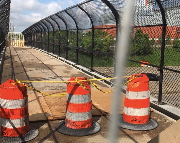 The hole in the pedestrian bridge covered and blocked off 