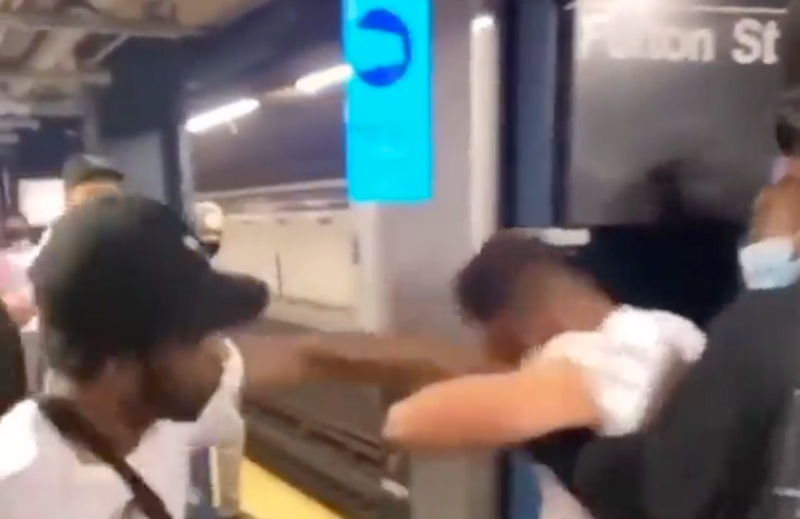 Police are searching for three men seen slapping, punching and holding down a man in the Fulton Street subway station