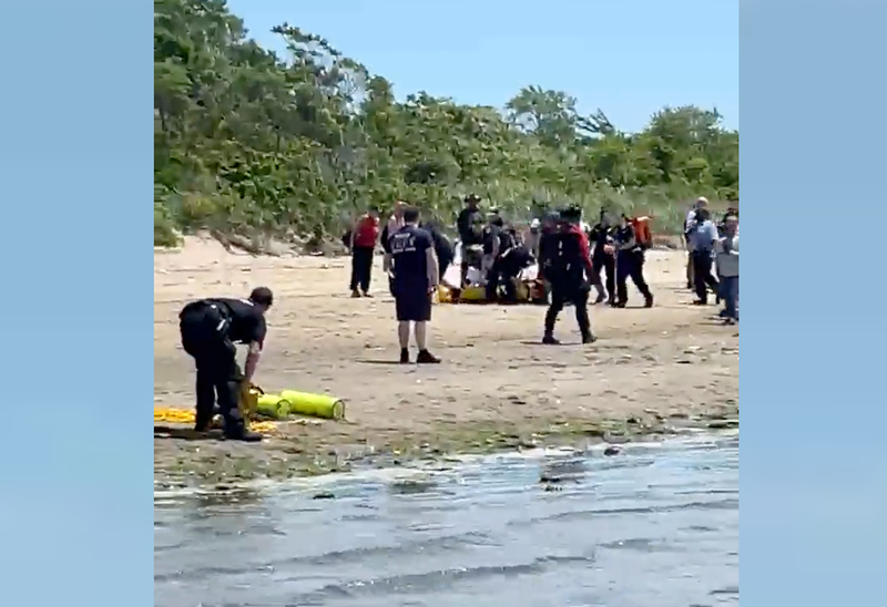 Emergency responders were seen carrying someone on the beach
