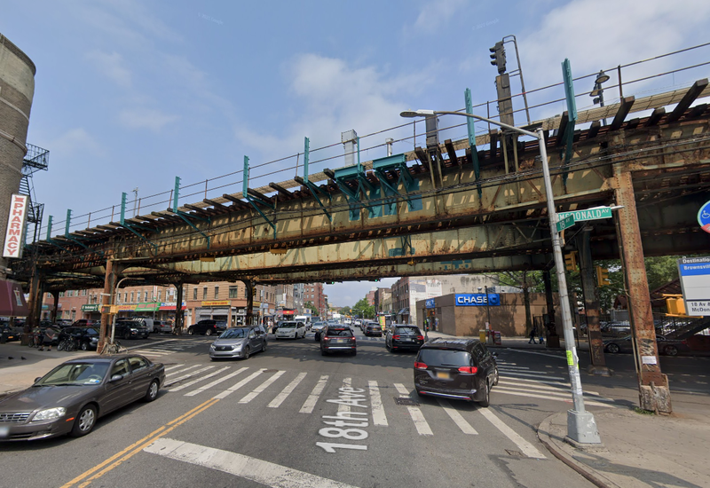 A private sanitation truck collided with a pillar supporting the elevated 18th Avenue station in Borough Park early Wednesday
