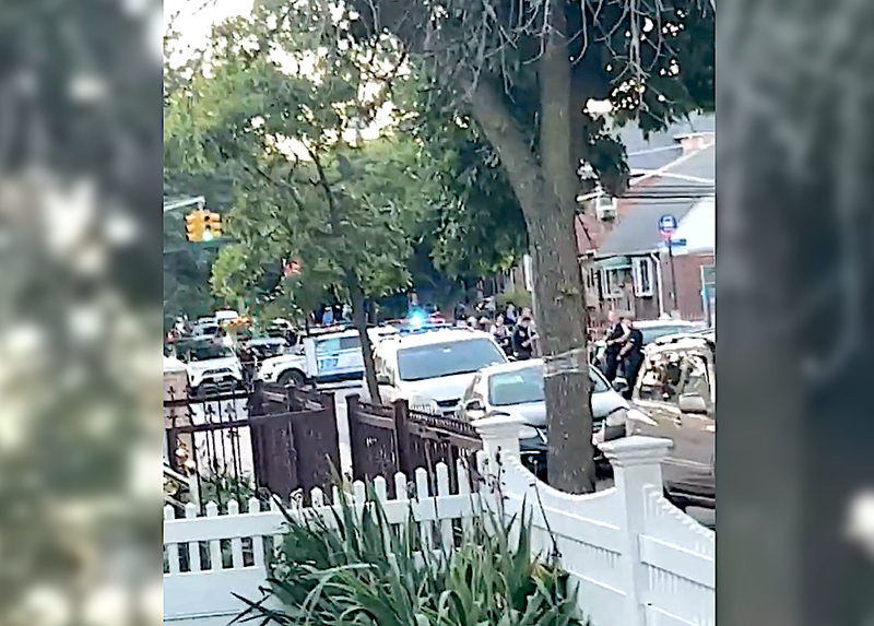 Police at the scene of the shooting in South Jamaica on Wednesday night