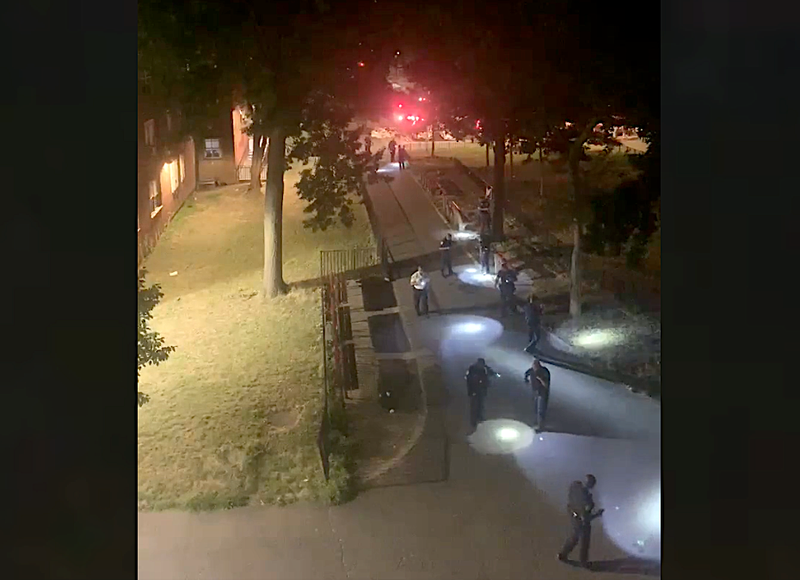 Police officers canvass a courtyard near 229th Drive North and East 229th Street at the Edenwald Houses following a shooting early Thursday