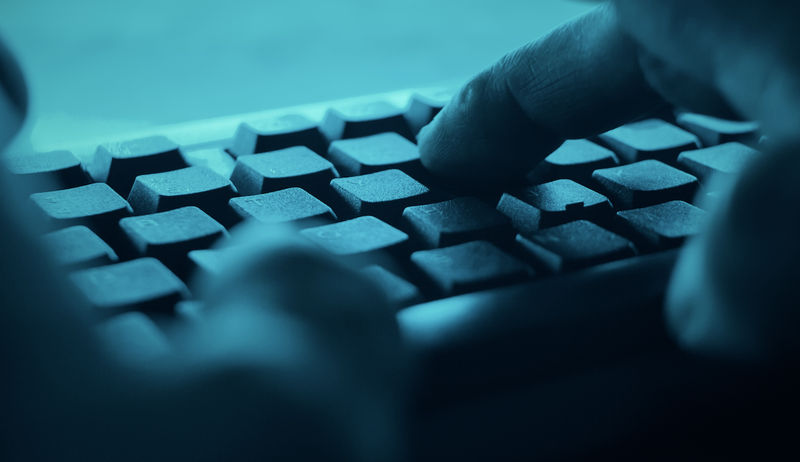 dark web fingers on keyboard