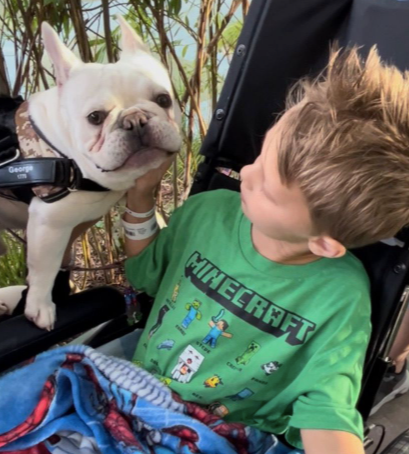 Cooper Roberts in wheelchair with dog