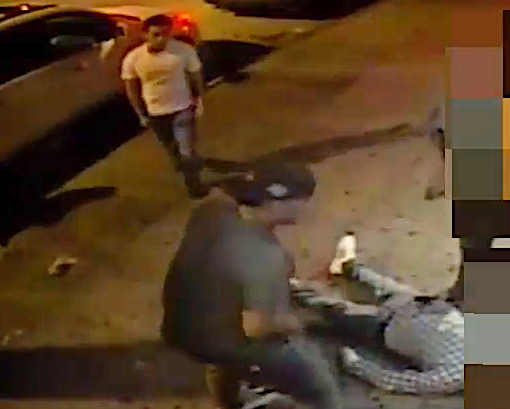 Video shows the victim motionless on the ground as two men rummage through his pockets