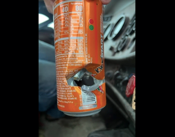 can with bullet hole