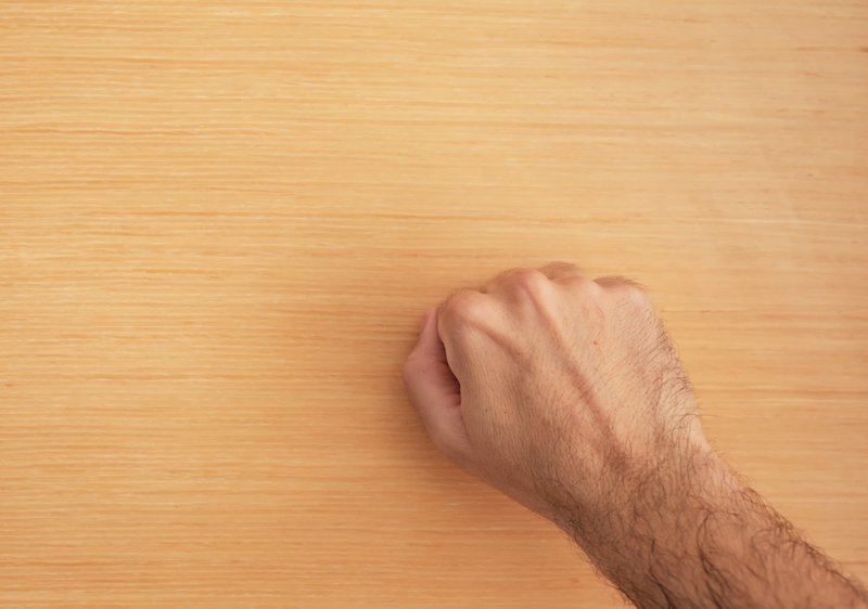 hand or fist knocking on door