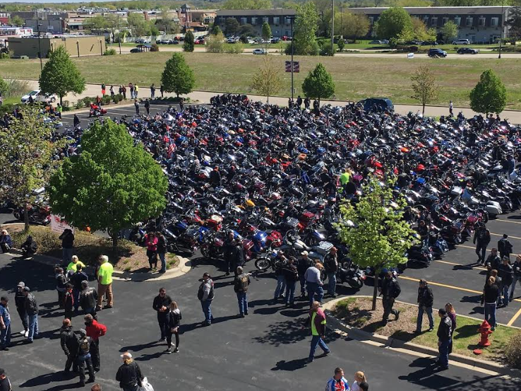 parking lot full of motorcycle riders