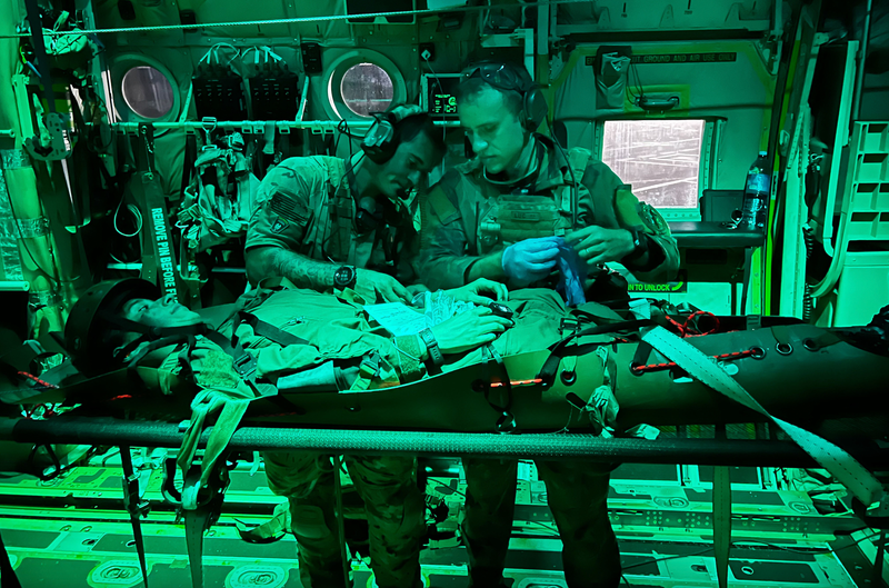 Air Force Senior Airman Matt Pluhoeski, right, works with a Brazilian service member during a simulated medical evacuation as part of Exercise Tapio in Campo Grande, Brazil, Aug. 24, 2022. Pluhoeski is a pararescue airman assigned to the 103rd Rescue Squadron of the New York Air National Guard’s 106th Rescue Squadron.