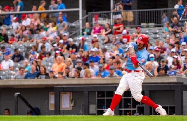 Baseball player swings at a pitch