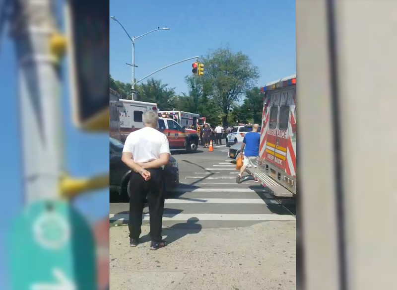 Police and EMS gather around the area where a teenager was shot in Brighton Beach on Friday.