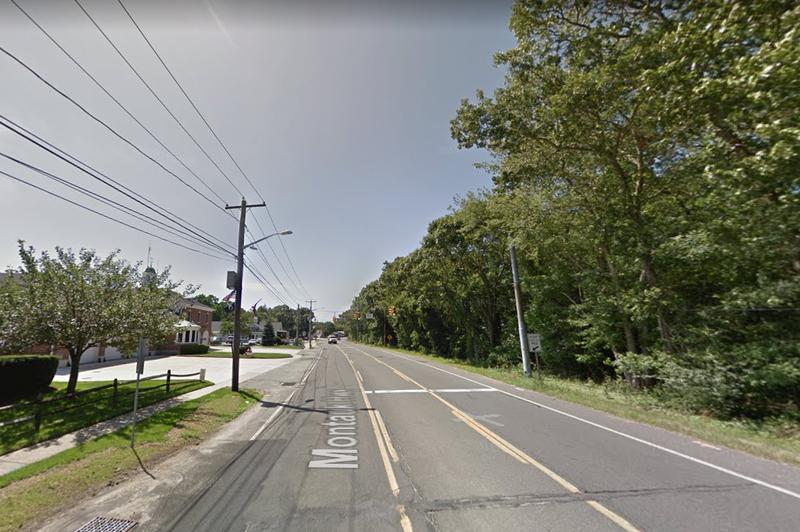 The car crashed into a utility pole at Montauk Highway and Carman Boulevard in Brookhaven shortly before 8 p.m. Thursday