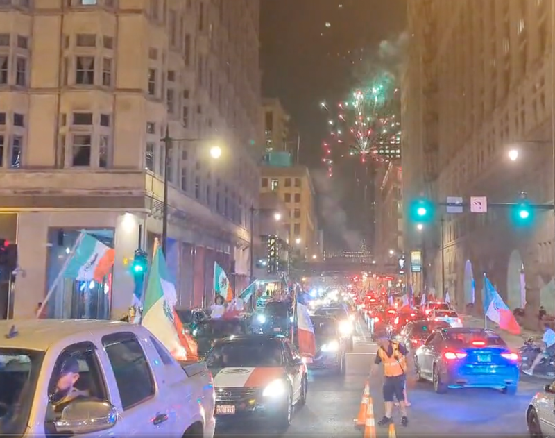 Cars flying Mexican flags drive through downtown Chicago