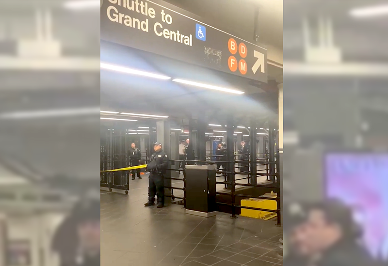 Police tape was up at the mezzanine to the 42nd Street Shuttle as the NYPD investigated