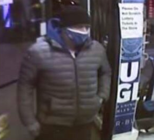 suspect in jacket with mask