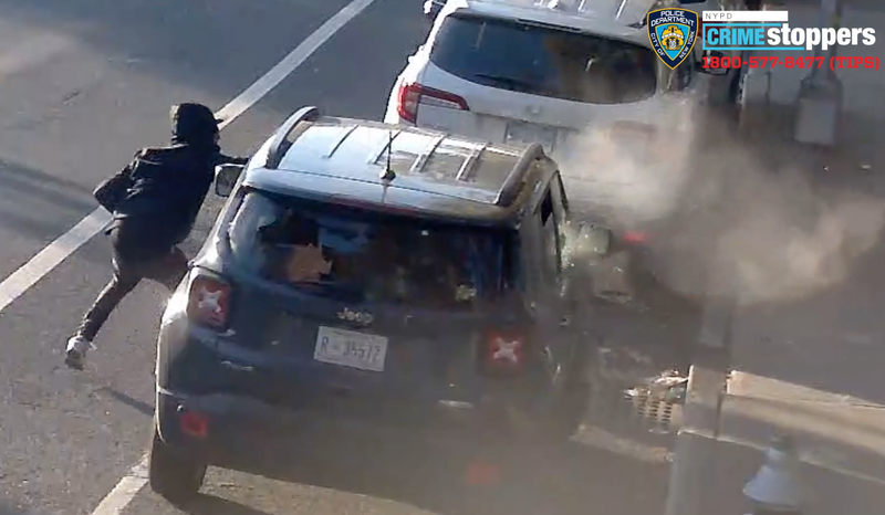The man ducks for cover and fires shots before fleeing, video shows