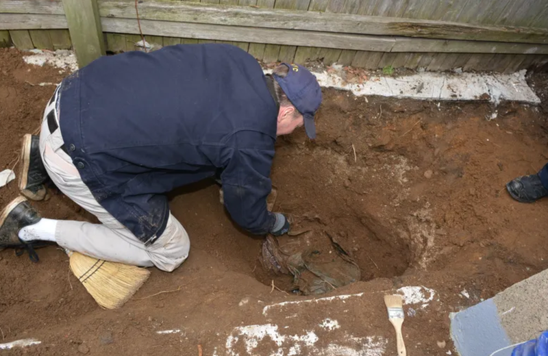 Investigators in the backyard of a home in Richmond Hill where Martin Motta buried the remains of George Clarence Seitz.
