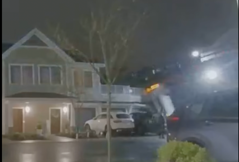 Surveillance video of car falling onto house from embankment