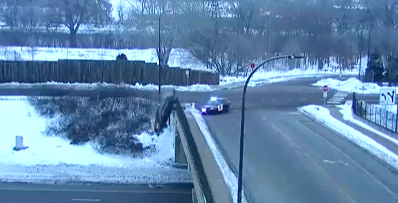 Car drives over overpass