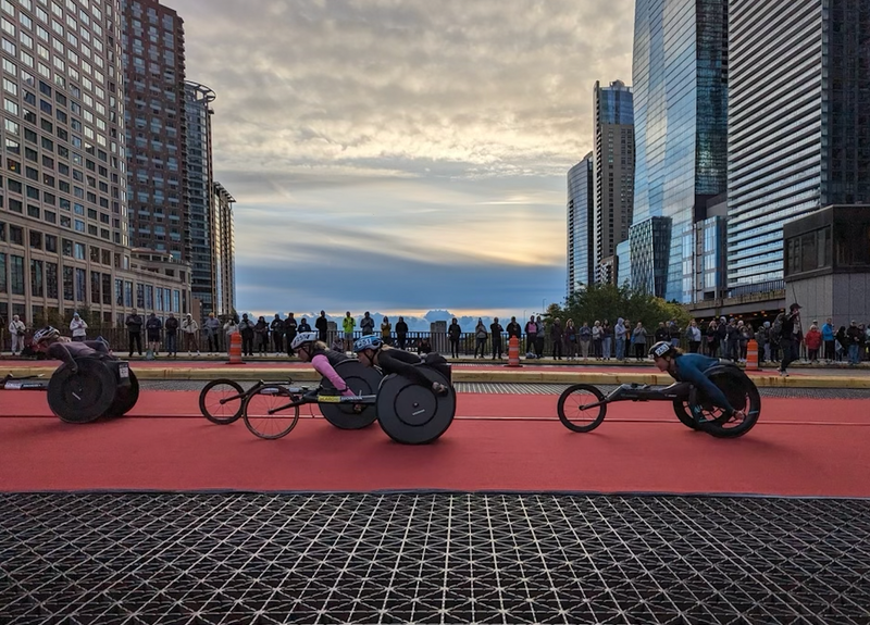 Wheelchair marathoners race across downtown during the 2023 Chicago Marathon.