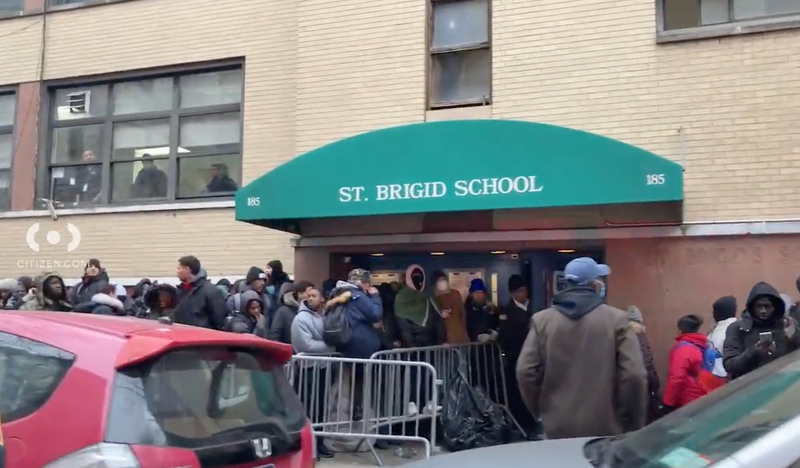 Migrants waiting outside of an intake center in the East Village on Saturday morning.