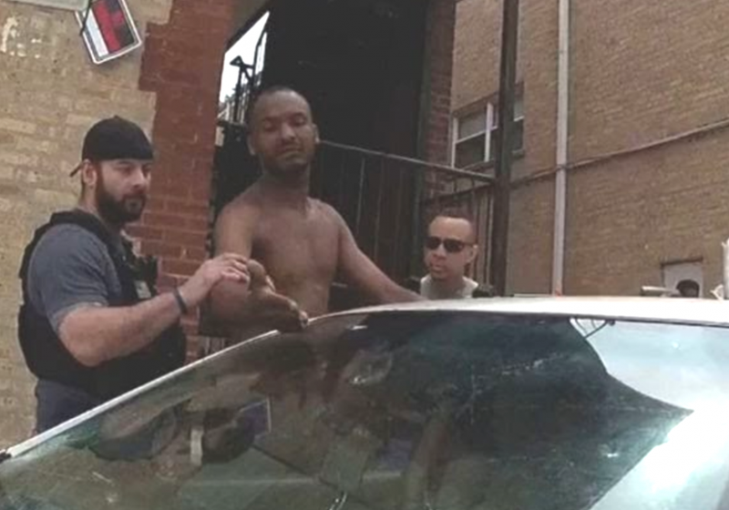 A video still allegedly shows two Evanston police officers allegedly use excessive force against a man in a parking lot.