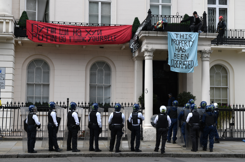 Police officers in riot gear arrive as protesters occupy a building reported to belong to Russian oligarch Oleg Deripsaka on March 14, 2022 in London