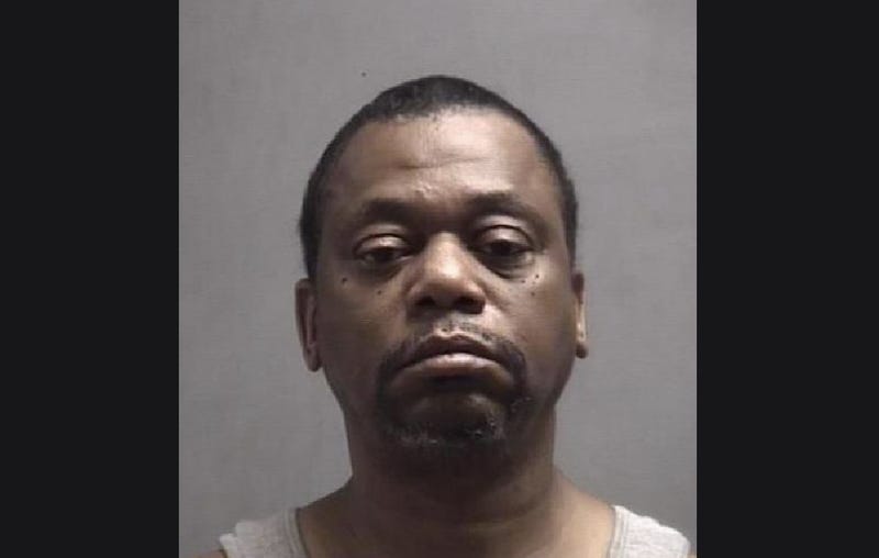 Older Black man frowning with black hair and black beard 