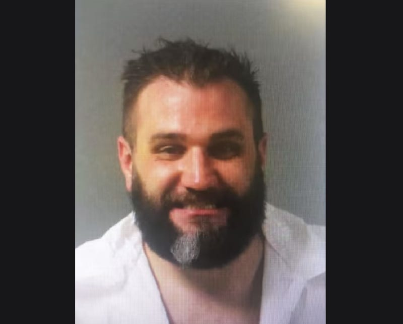 Olderman with brown hair and beard smiling