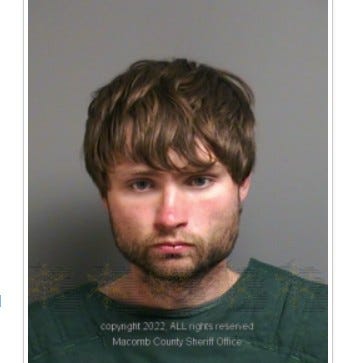 White man in 20s with shaggy brown hair and brown beard