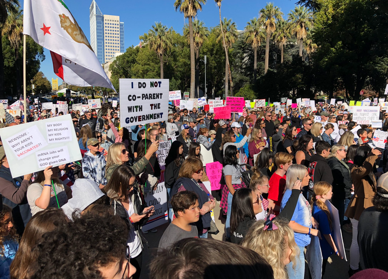 Thousands rally outside the California State Capitol against the state's COVID-19 vaccine mandate for students.