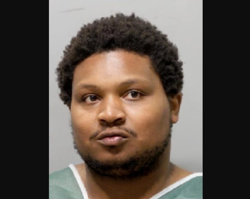 Black man in 30s with short afro and short black beard 