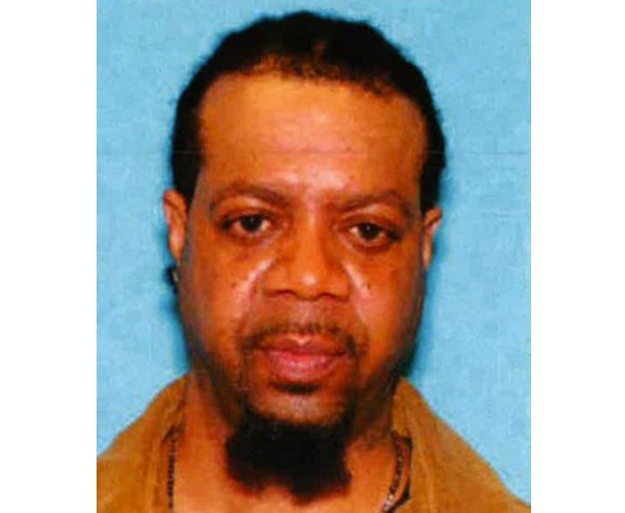 Older Black man with short black hair and black beard