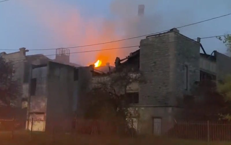 Big building with flames coming out of top